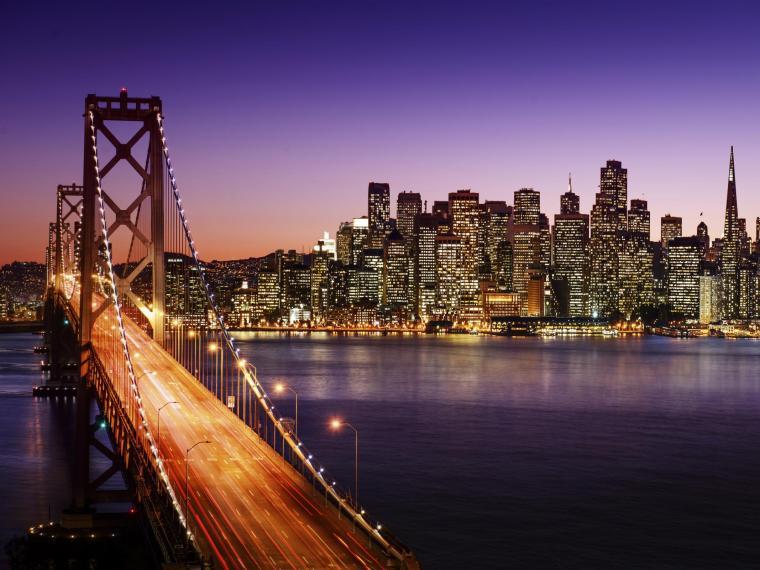 San Francisco, CA skyline and Bay Bridge at sunset